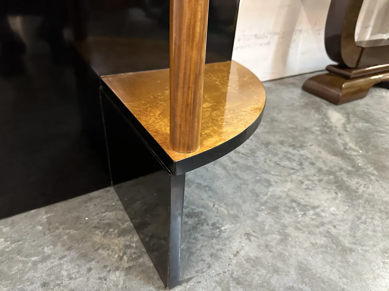 Visão próxima de duas mesinhas antigas com decorações art deco, detalhe de canto.