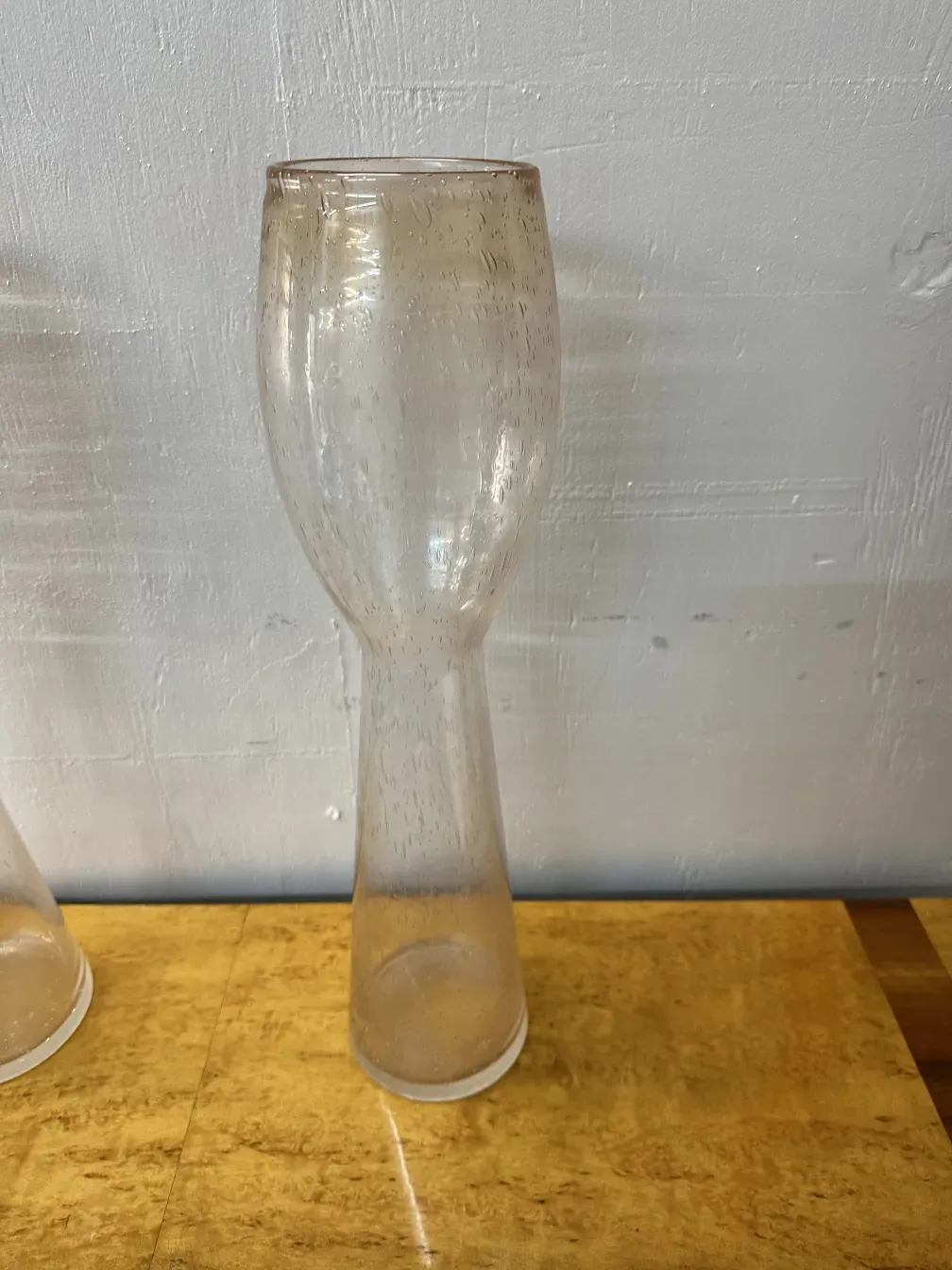 Two vintage Murano vases with elegant shape in a warm setting.