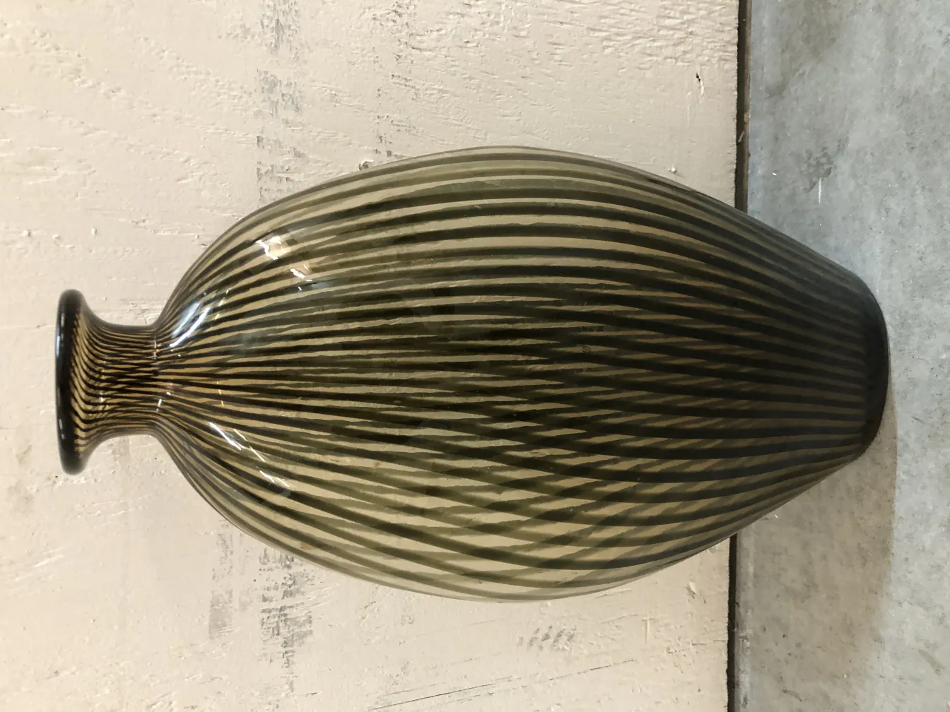 Two antique Murano vases, striped design in dark tones.