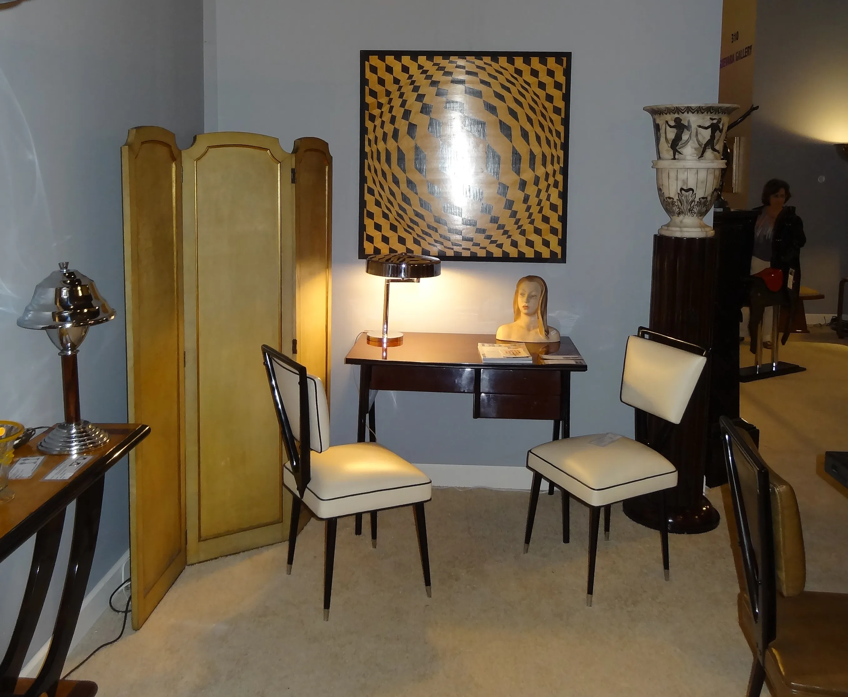Antique marquetry in a cozy setting, with lamp and chairs