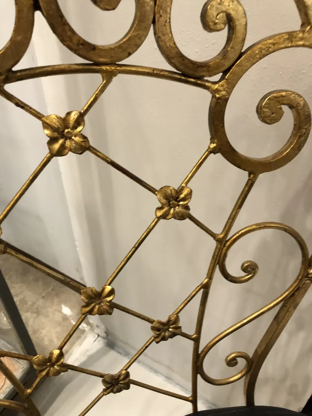 Two antique art deco garden armchairs with intricate designs