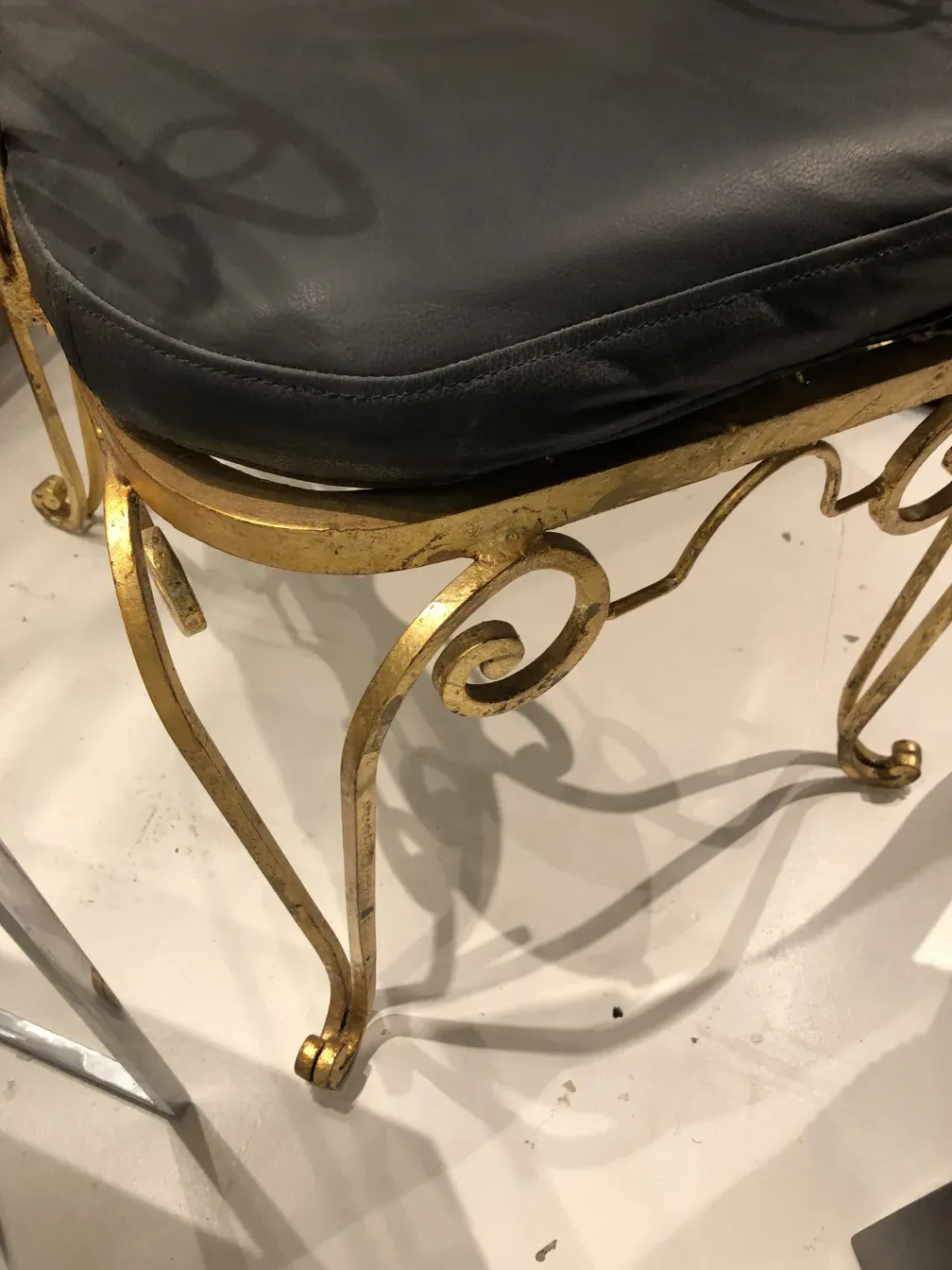 Antique art deco garden armchairs with elegant curves, set in a minimalistic environment.