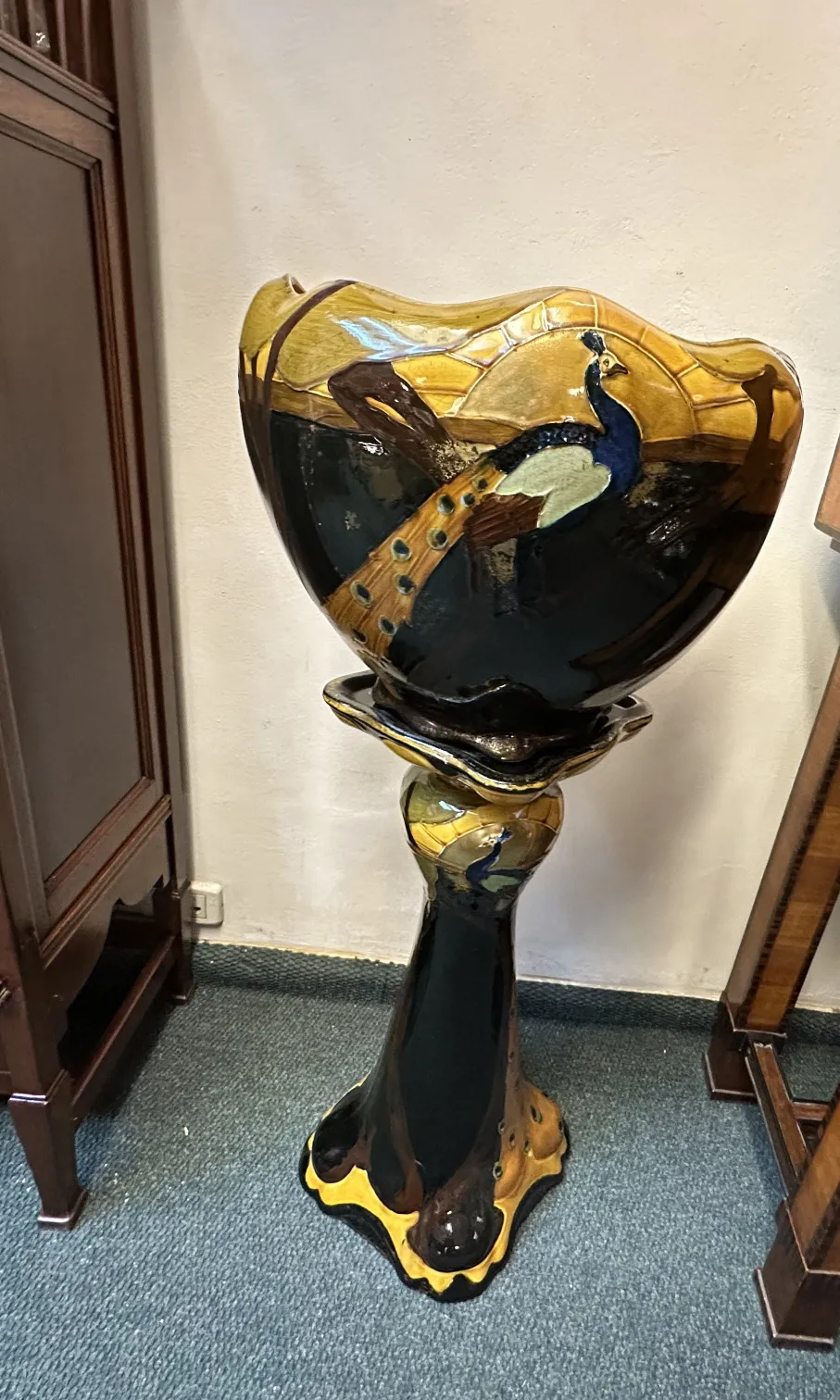 vibrant antique planter with peacock motif, classic setting