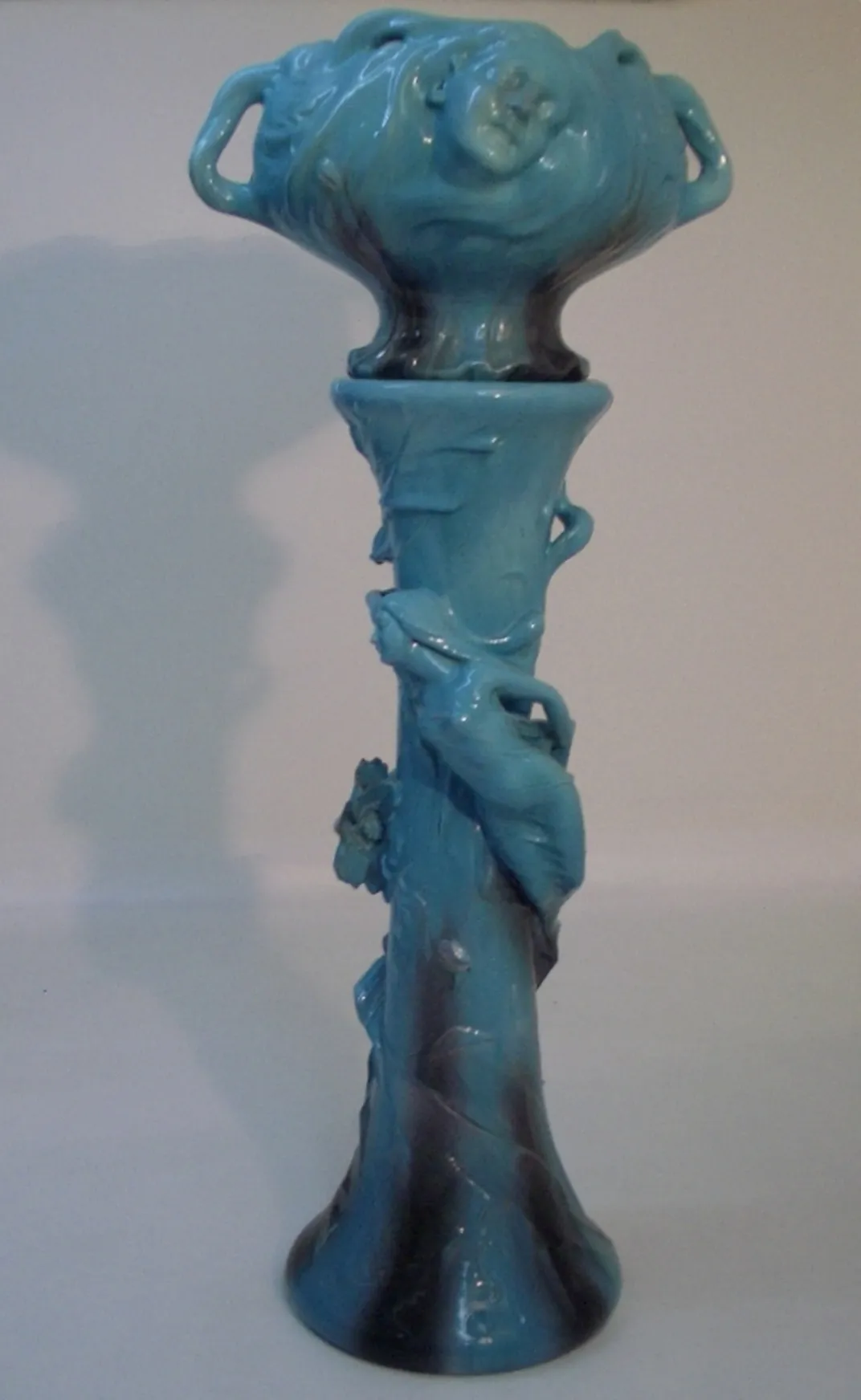 antique planter by Delphin Massier featuring decorative design in blue and black