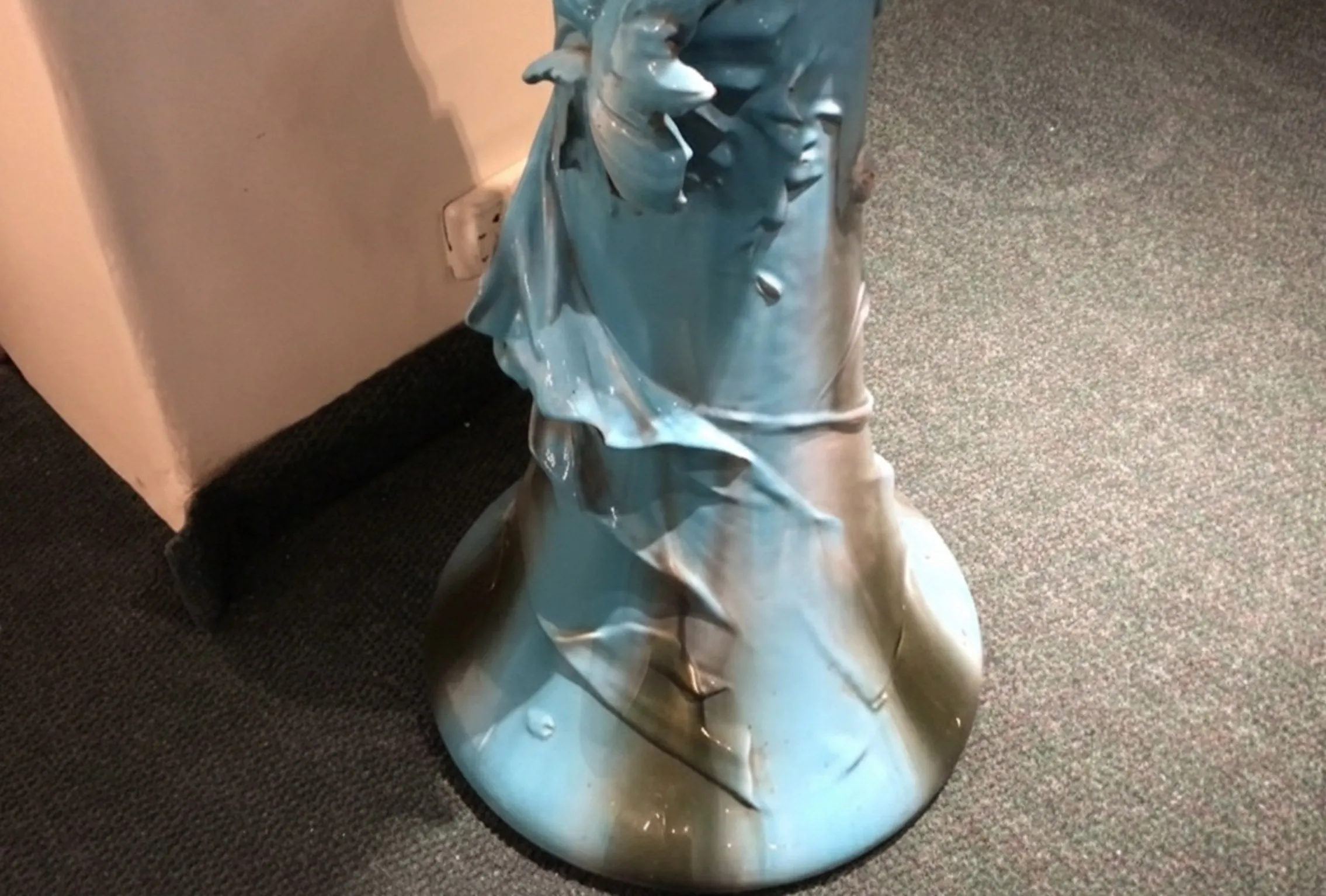 antique blue planter with ornamental details in an indoor setting