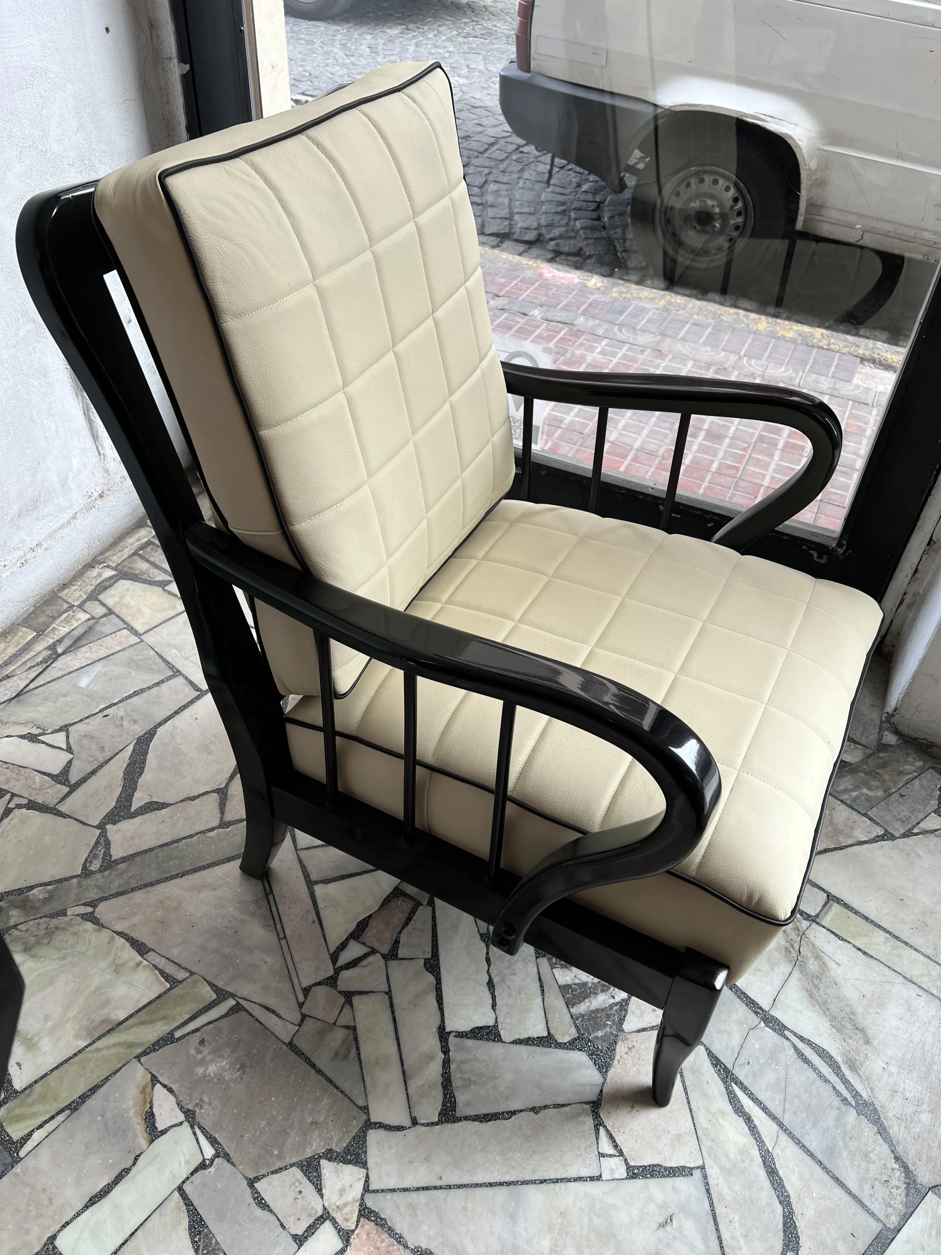 two antique light-colored armchairs with a modern design, decorating an elegant space