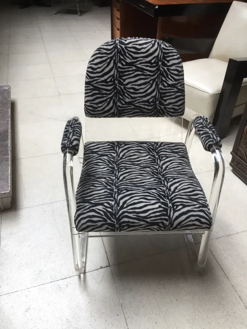 View of 2 antique armchairs with zebra print fabric, art deco style