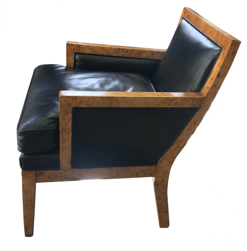 Deux fauteuils anciens de Jean Michel Frank, avec un design élégant, sur fond simple.