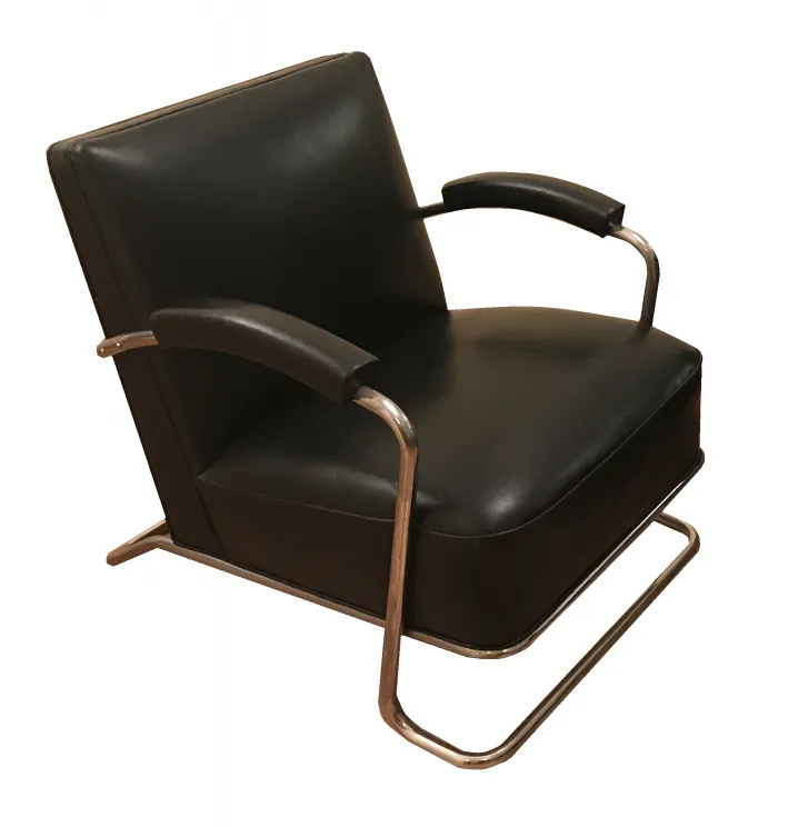 Two antique art deco armchairs with a stylish design.