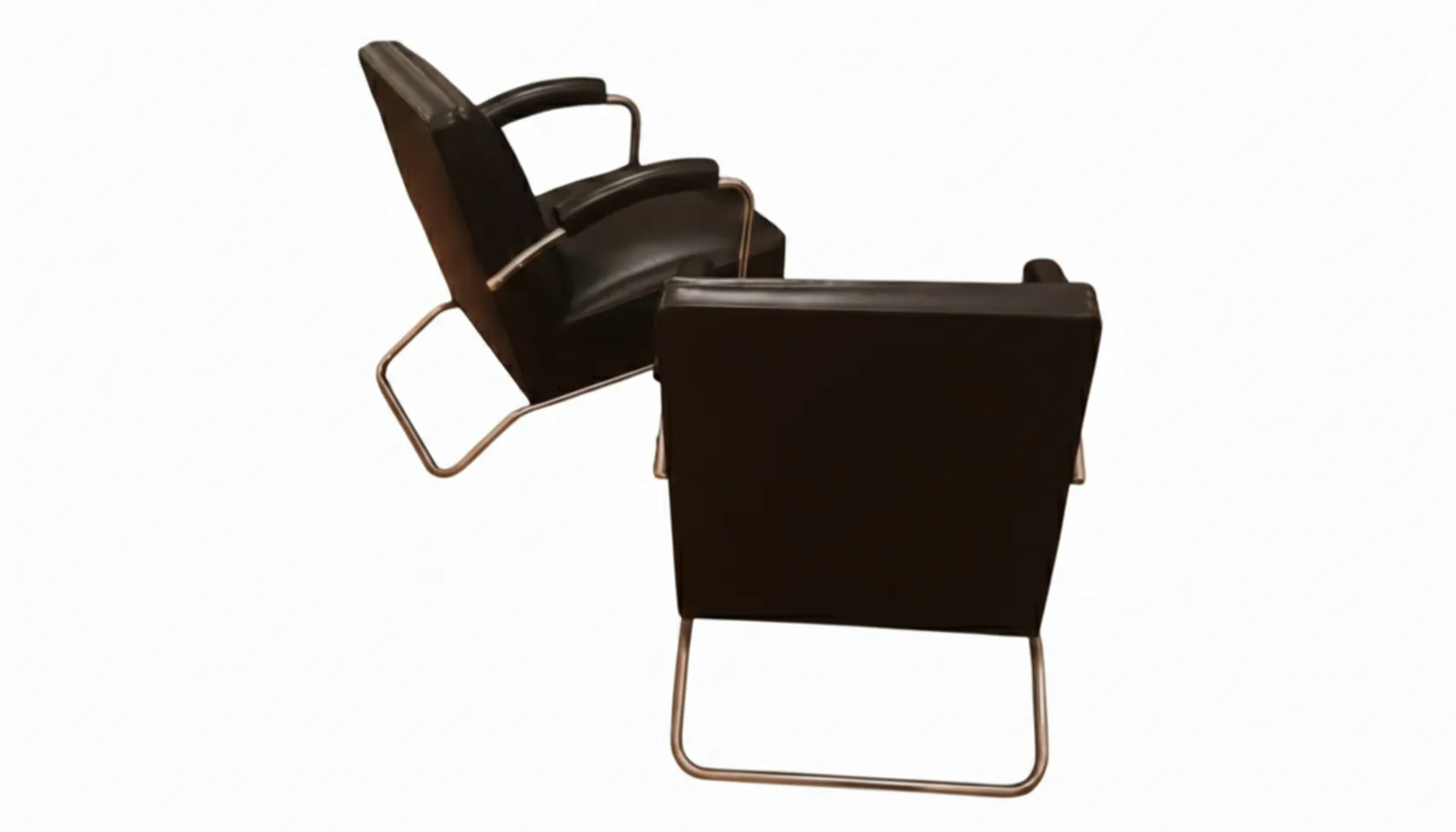 Rear view of two antique armchairs with elegant lines in a minimalist setting.