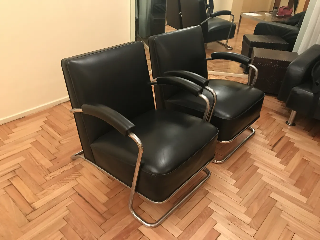 two antique armchairs in a cozy setting with wooden floor