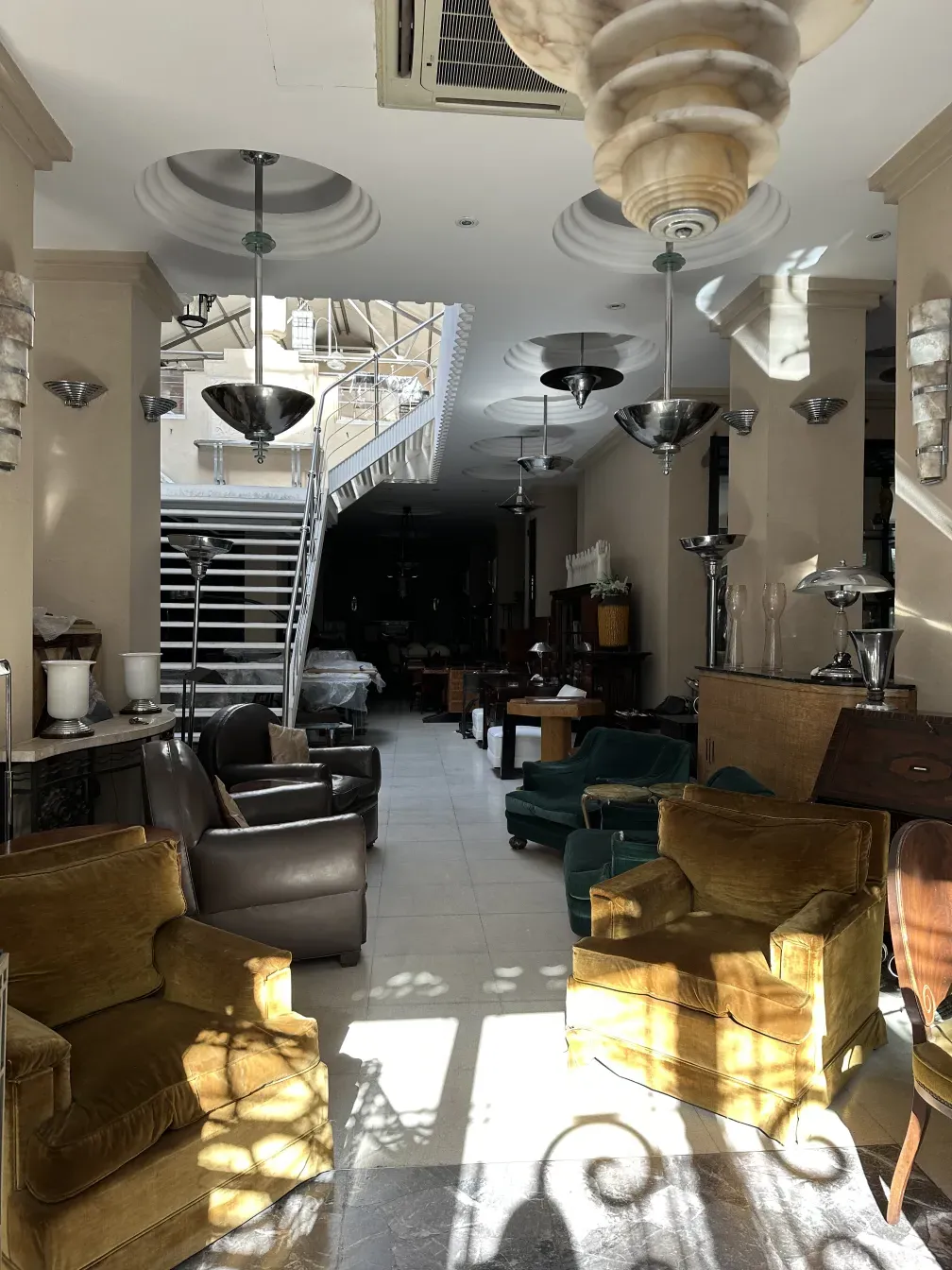 two antique armchairs in a well-lit environment.