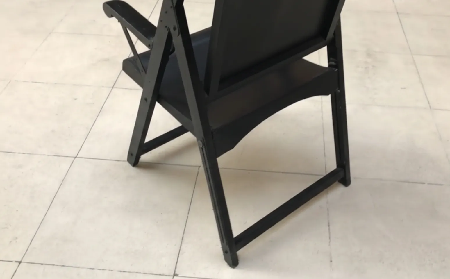 two antique black armchairs ready for restoration in a cozy setting.