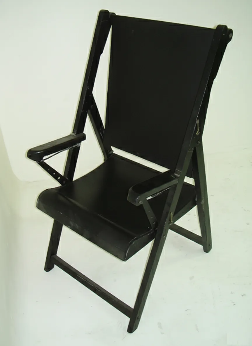 Black antique armchairs with visible structure in a simple setting.
