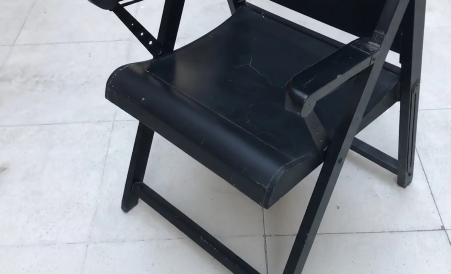 Two classic armchairs showing wear, need restoration, cozy setting.