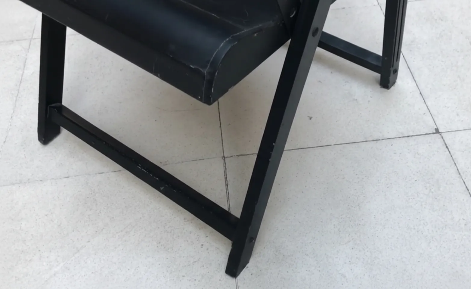 Two antique armchairs showing signs of wear, neutral background.