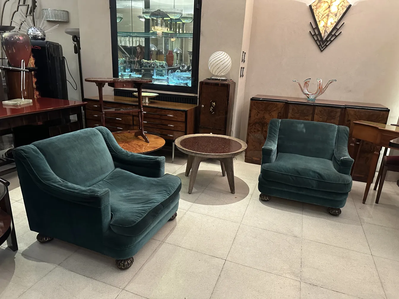 antique green upholstered armchairs in a retro setting with wooden furniture