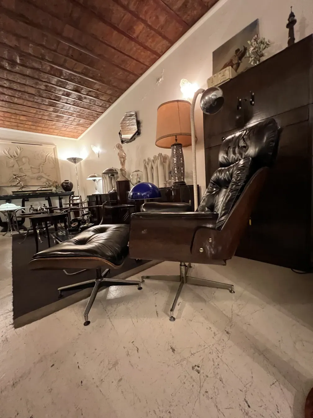 Antique armchair by Herman Miller needing restoration, set in a cozy environment.