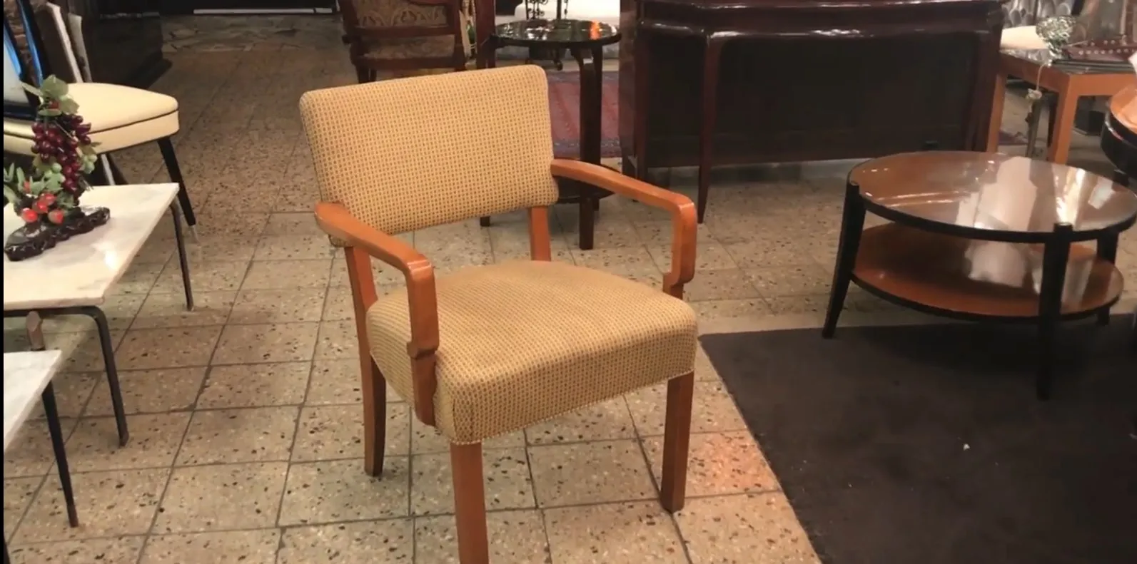 Antique desk chair with arms in an antique shop