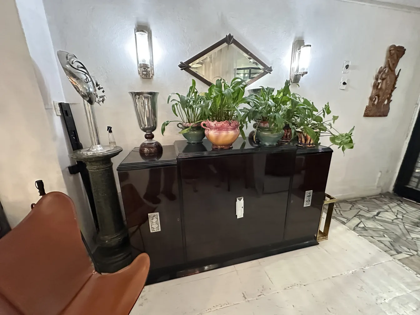 Antique BKF armchair with an elegant design surrounded by plants.