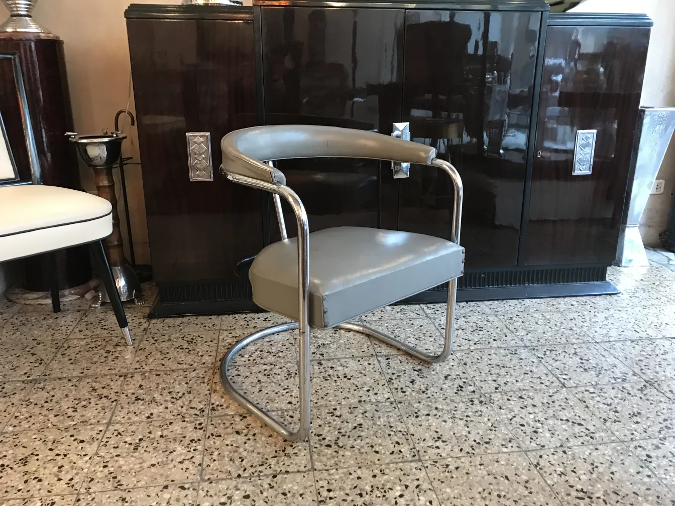 Two antique armchairs awaiting restoration in an antique setting.