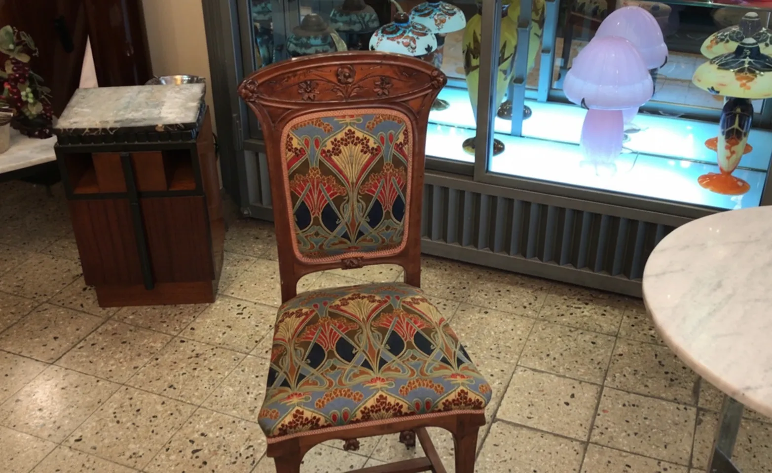 antique chair with colorful design, display case background