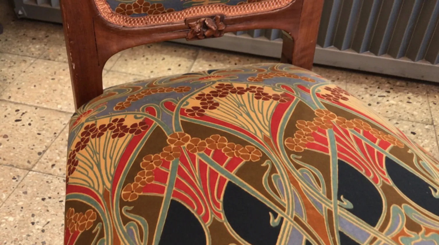 antique chair with artistic and colorful upholstery