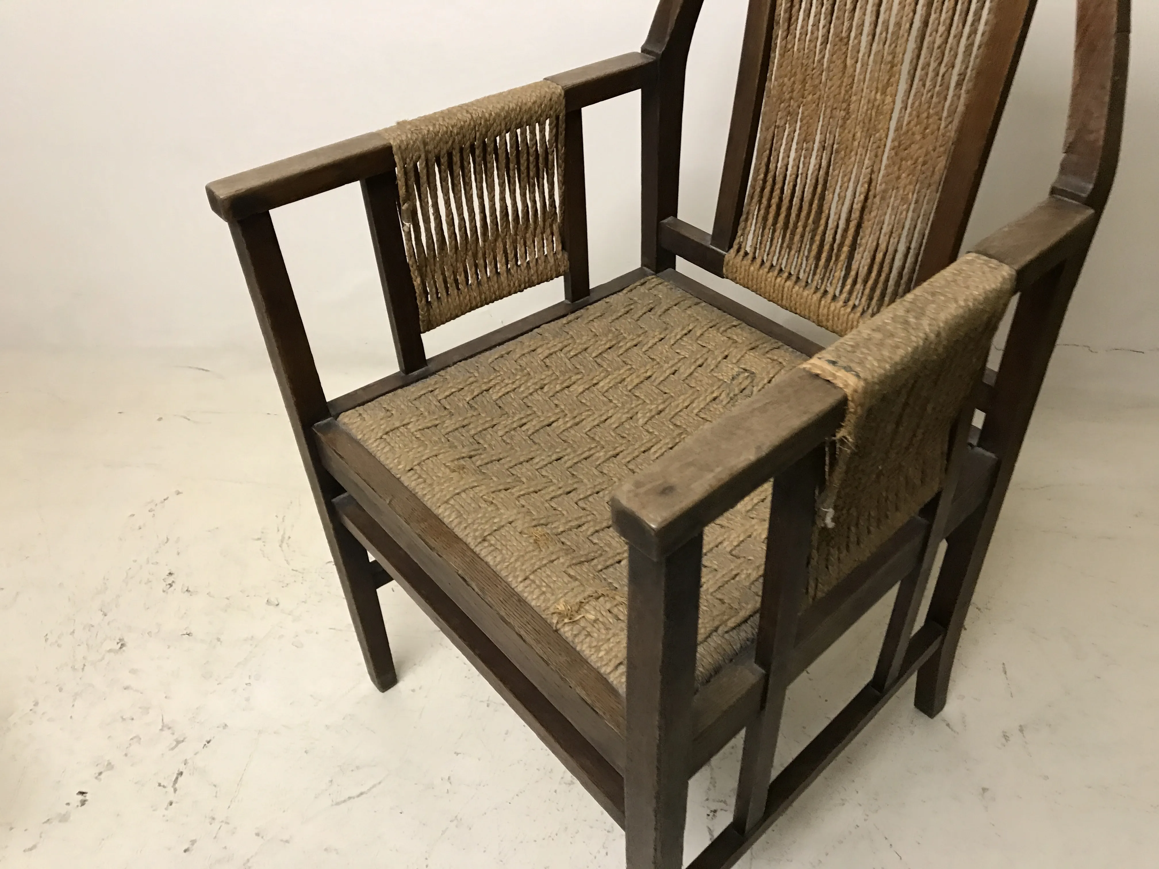 Antique desk chair by Edward Wormley featuring a simple design and woven seat.