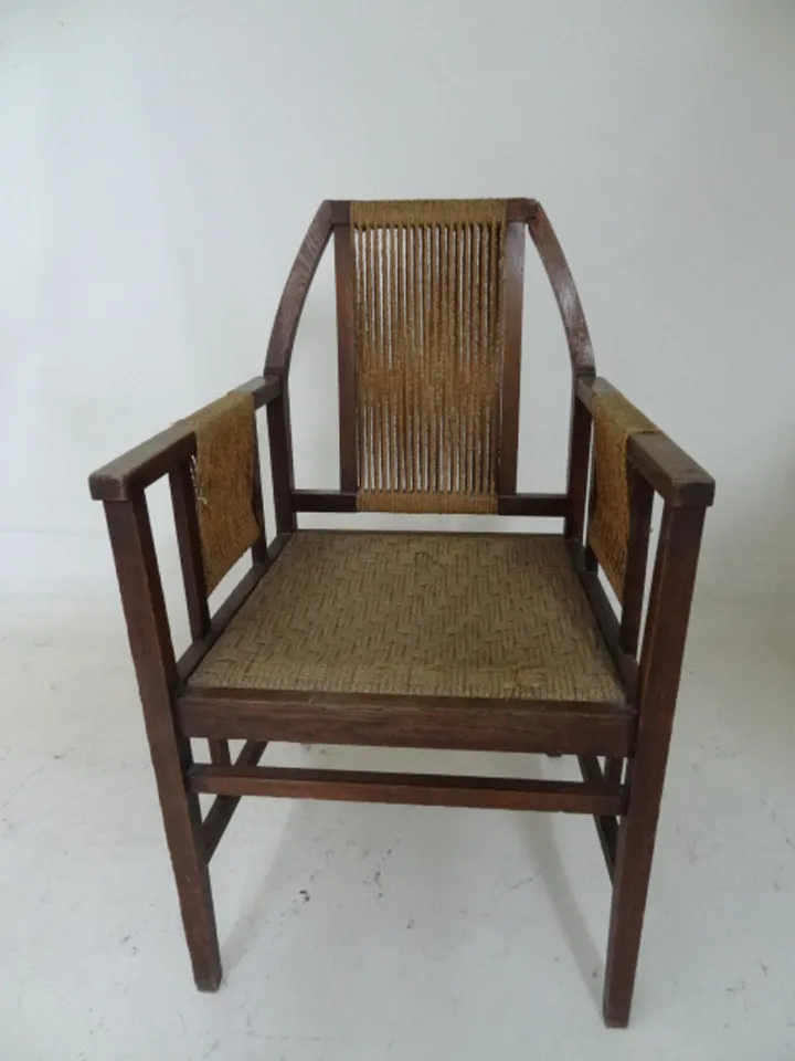 antique desk chair with slatted back and elegant arms, bright environment