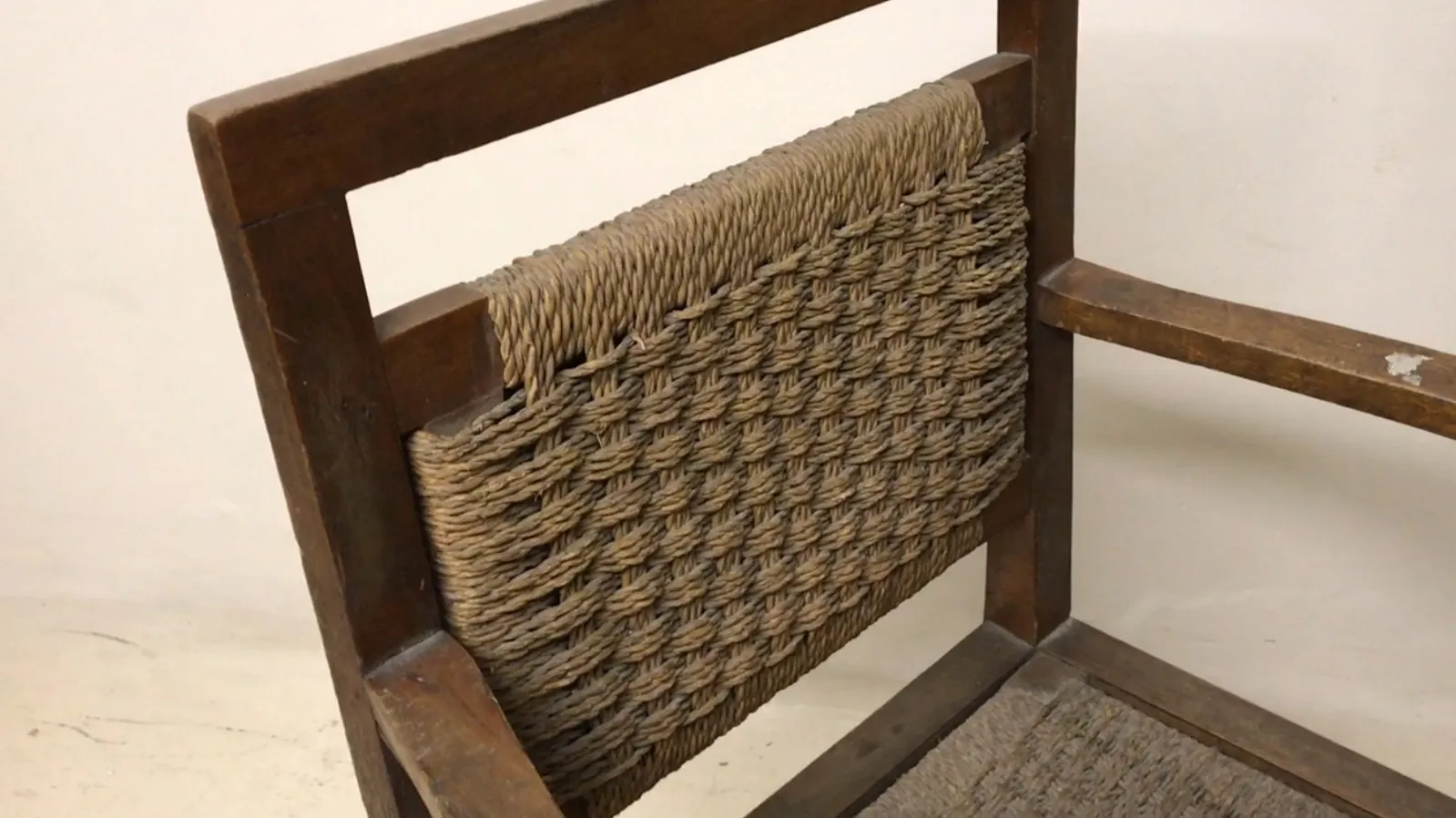 Antique armchair featuring Art Nouveau design with woven texture.