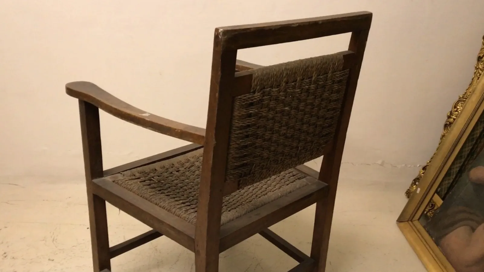Antique armchair with backrest in a simple setting