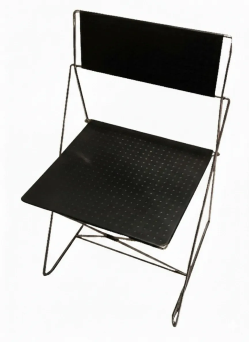 Two antique chairs with simple design, seen in a light setting.