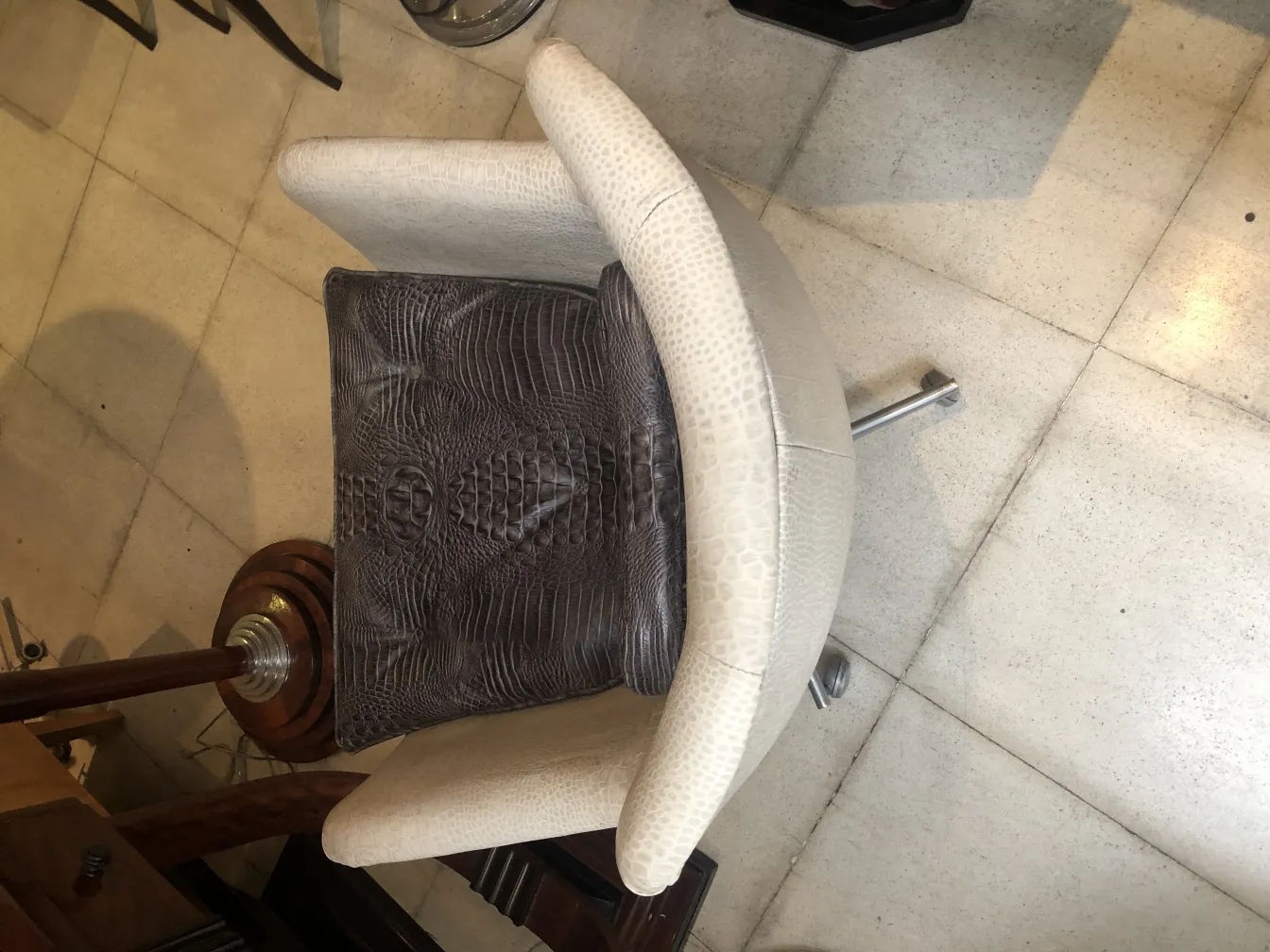 Antique armchair with contemporary design and dark cushion