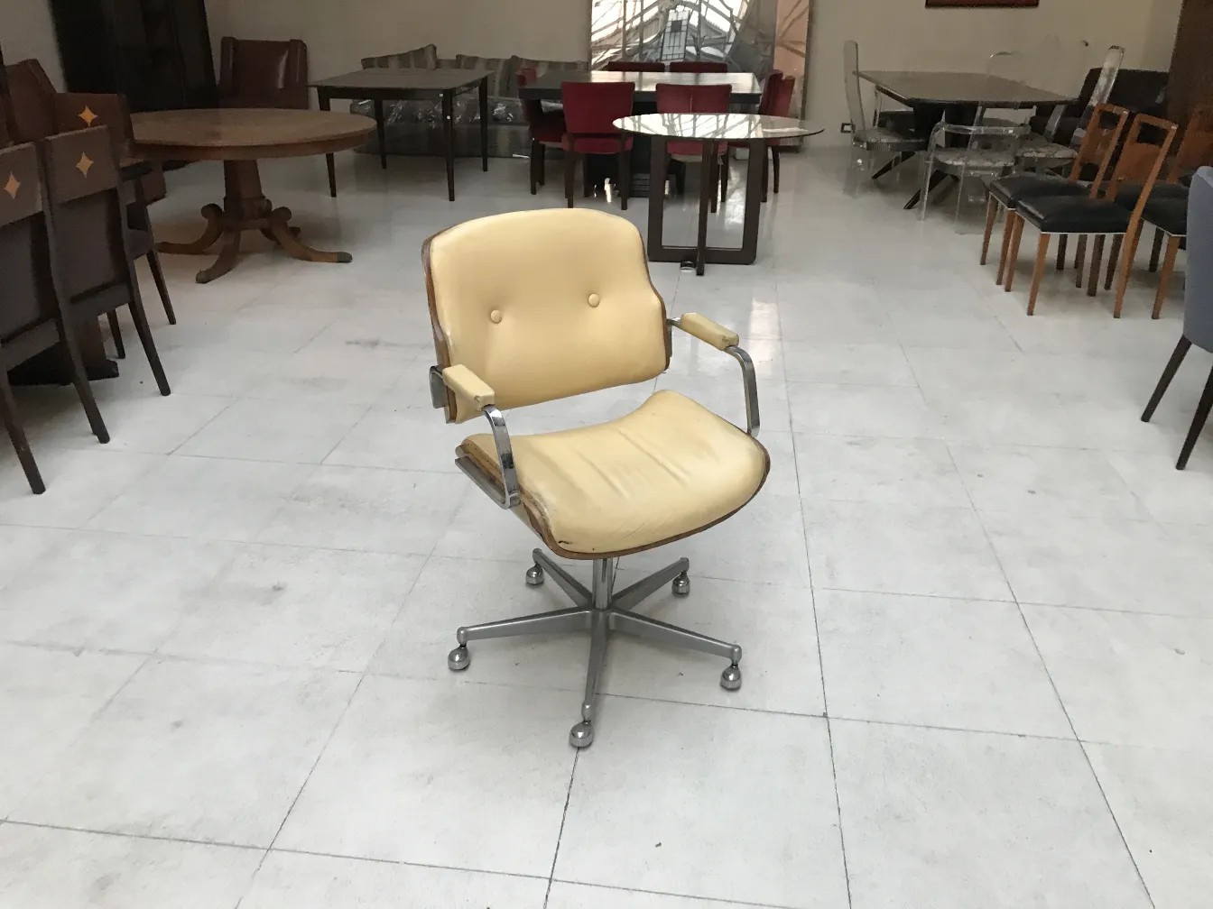 Antique desk armchair among other furniture pieces.