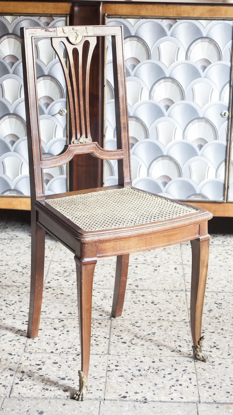 2 antique chairs with elegant design and space in the background