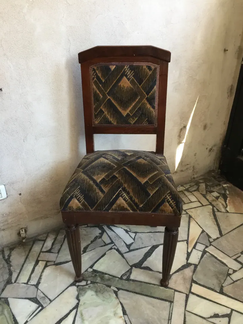 2 antique chairs with art deco design in rustic setting