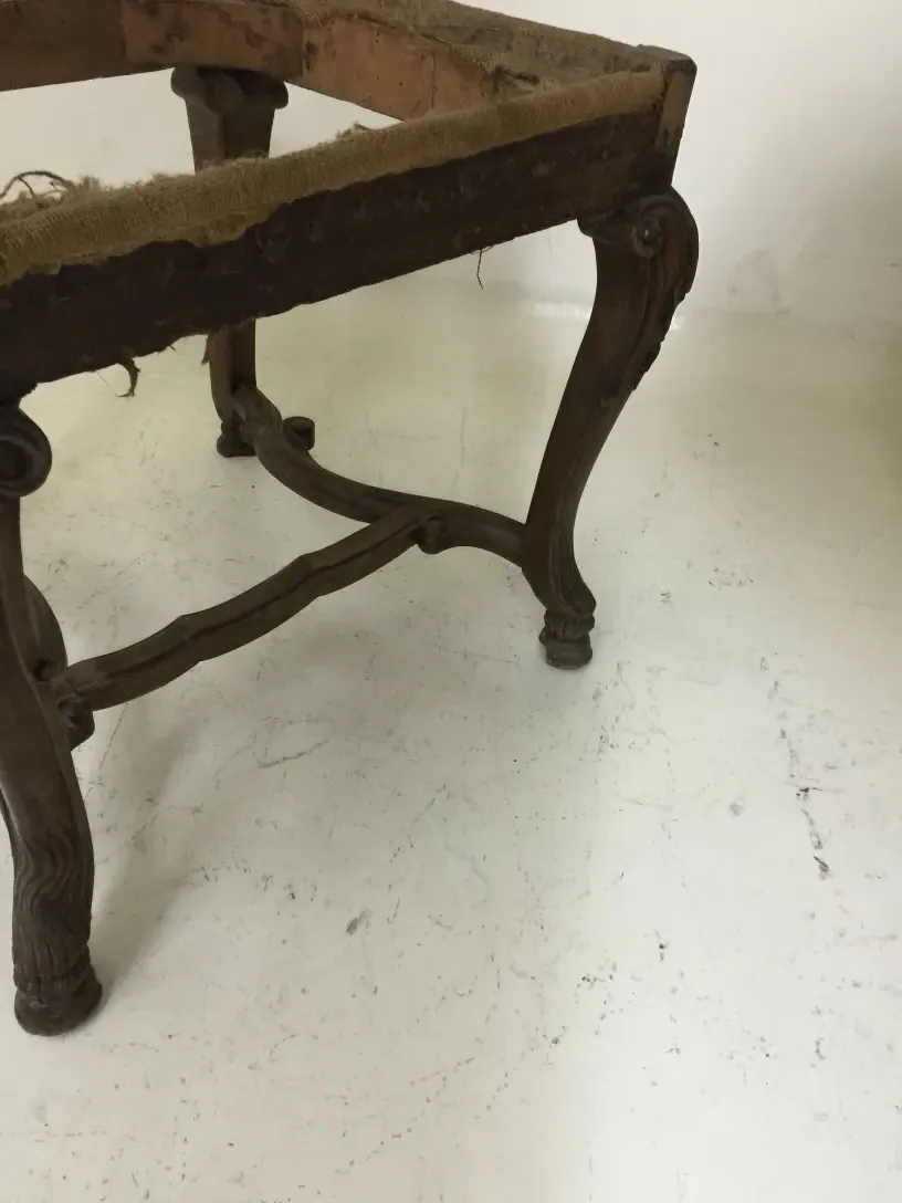 two antique chairs with worn structure ready to restore, light background.