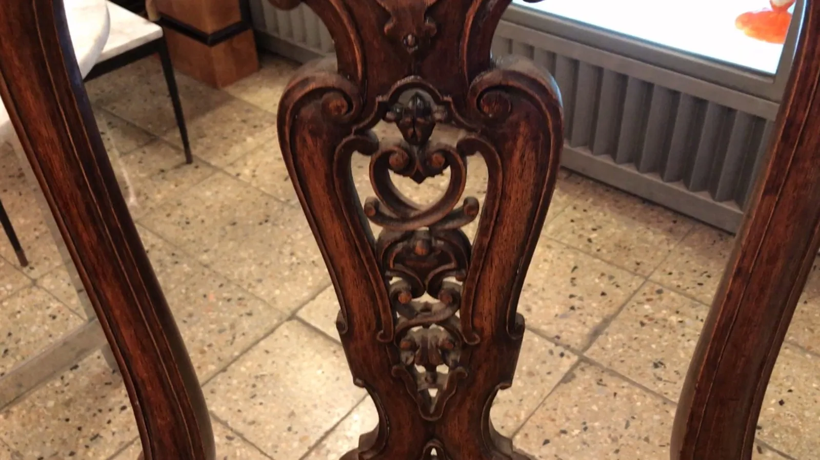 Detail of antique chairs with intricate design in a classic setting