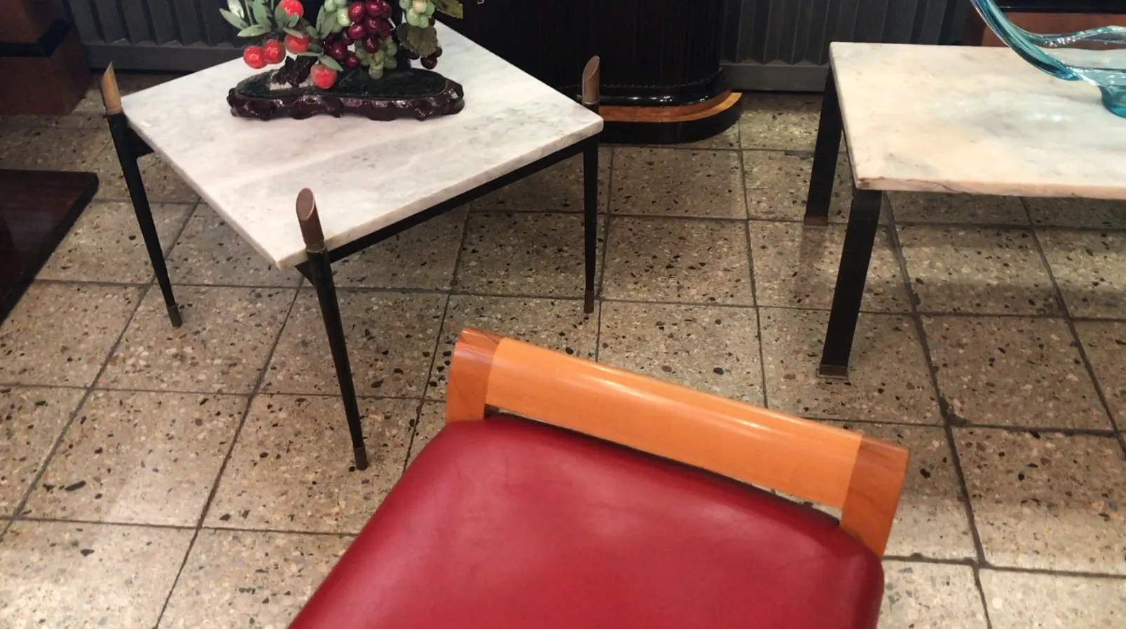 vintage sidewalk chair with red upholstery in a classic setting