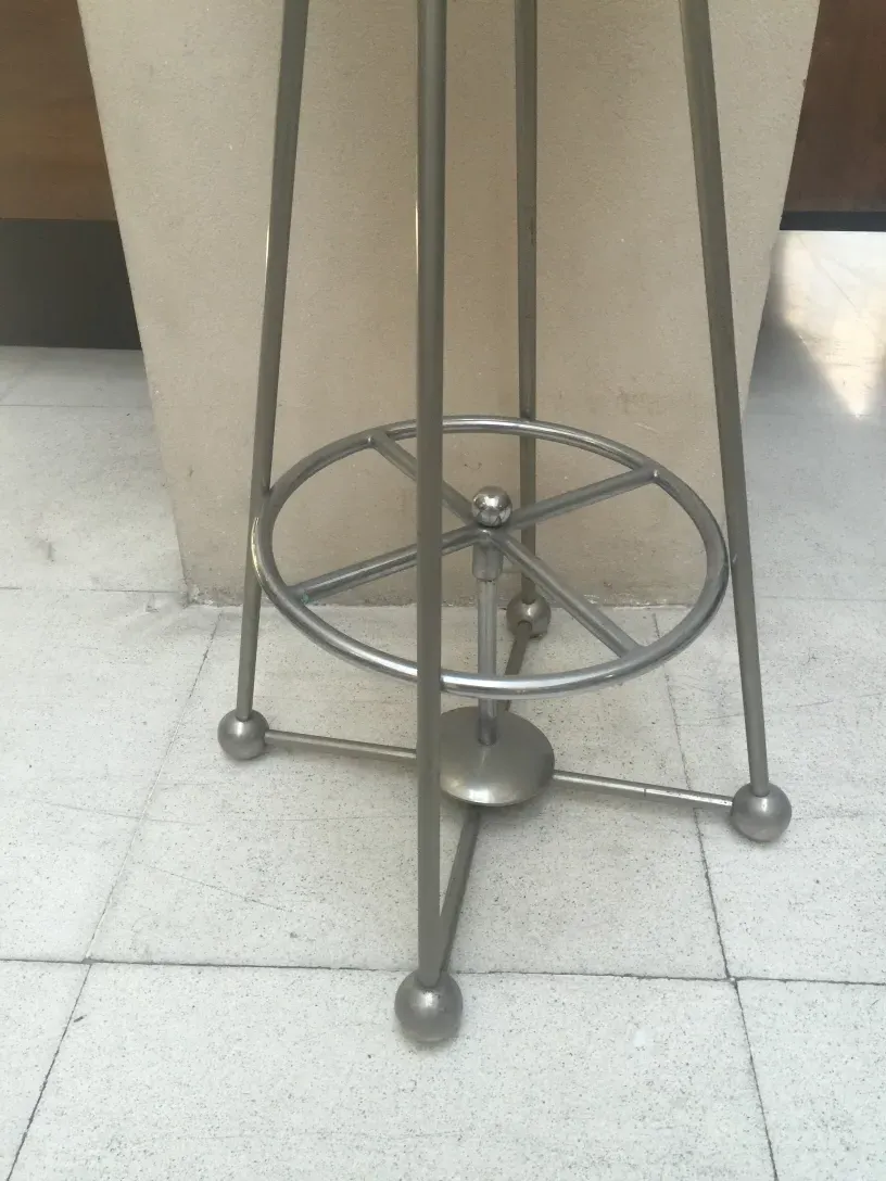 antique stool with slender legs and circular design