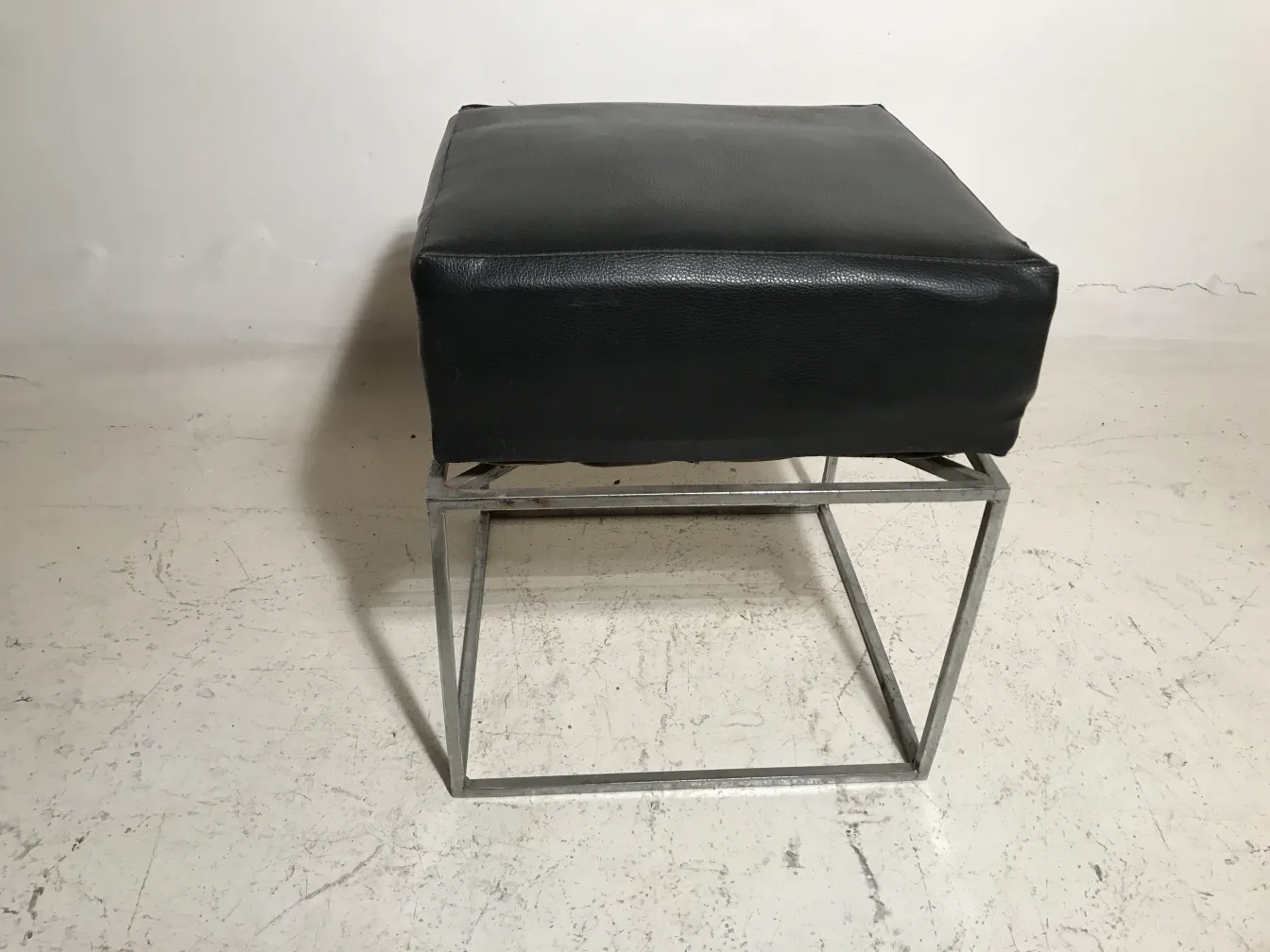 old-style sidewalk pouffe with a simple black design