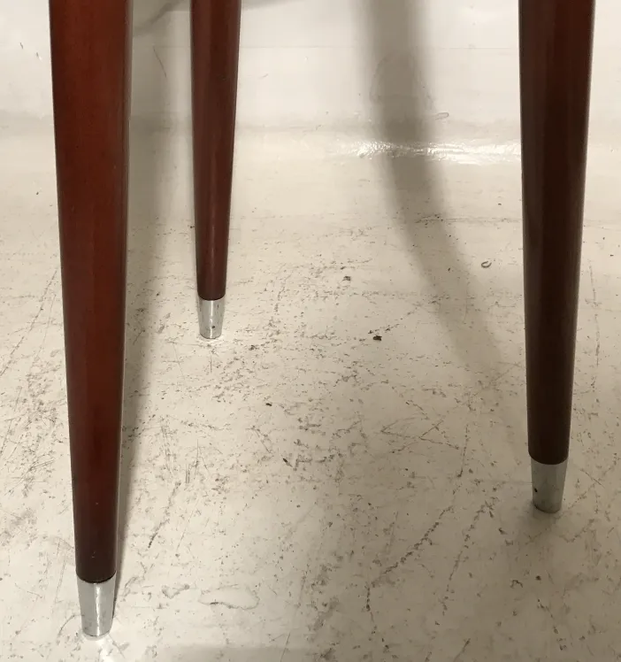 View of legs of an antique sidewalk with simple design.