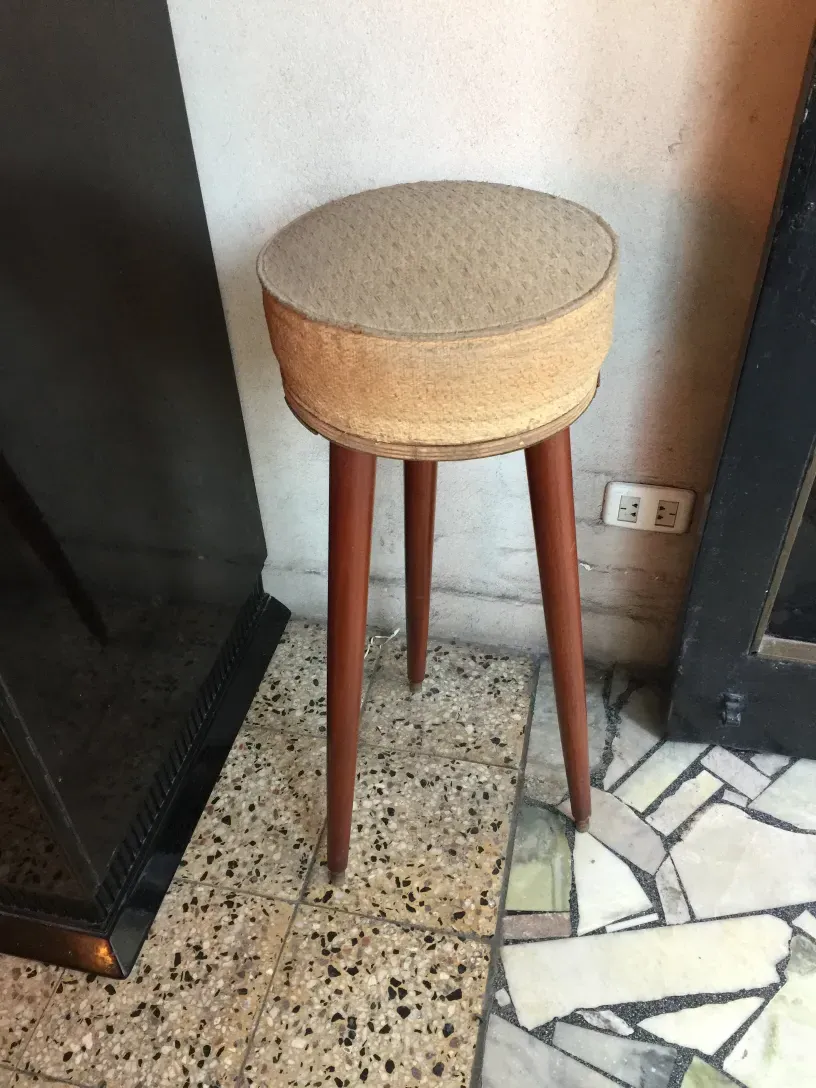 antiker Hocker mit Holzbeinen und runder Sitzfläche, klassisches Ambiente