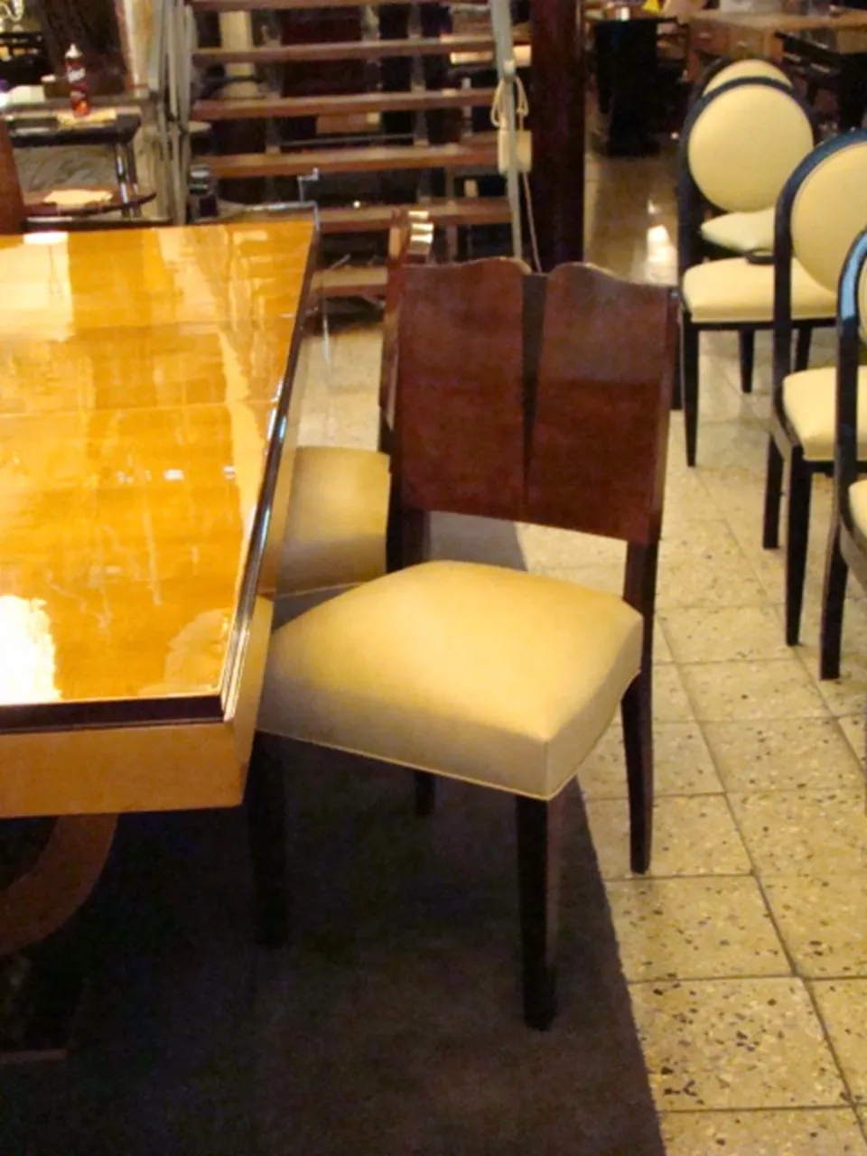 Antique classic armchair with elegant design, surrounded by chairs and a table