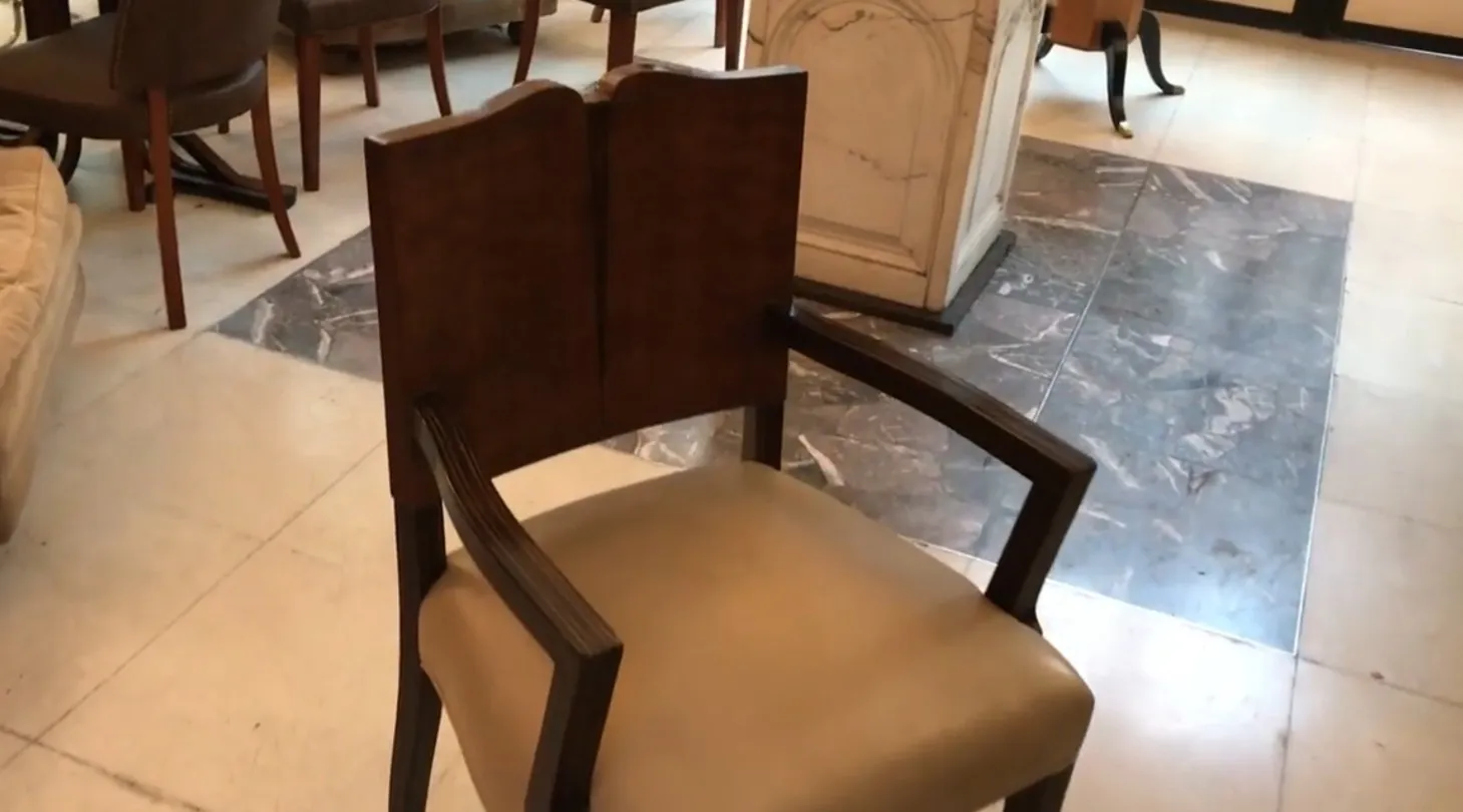 antique Art Deco armchair with arms and light upholstery in stylish room