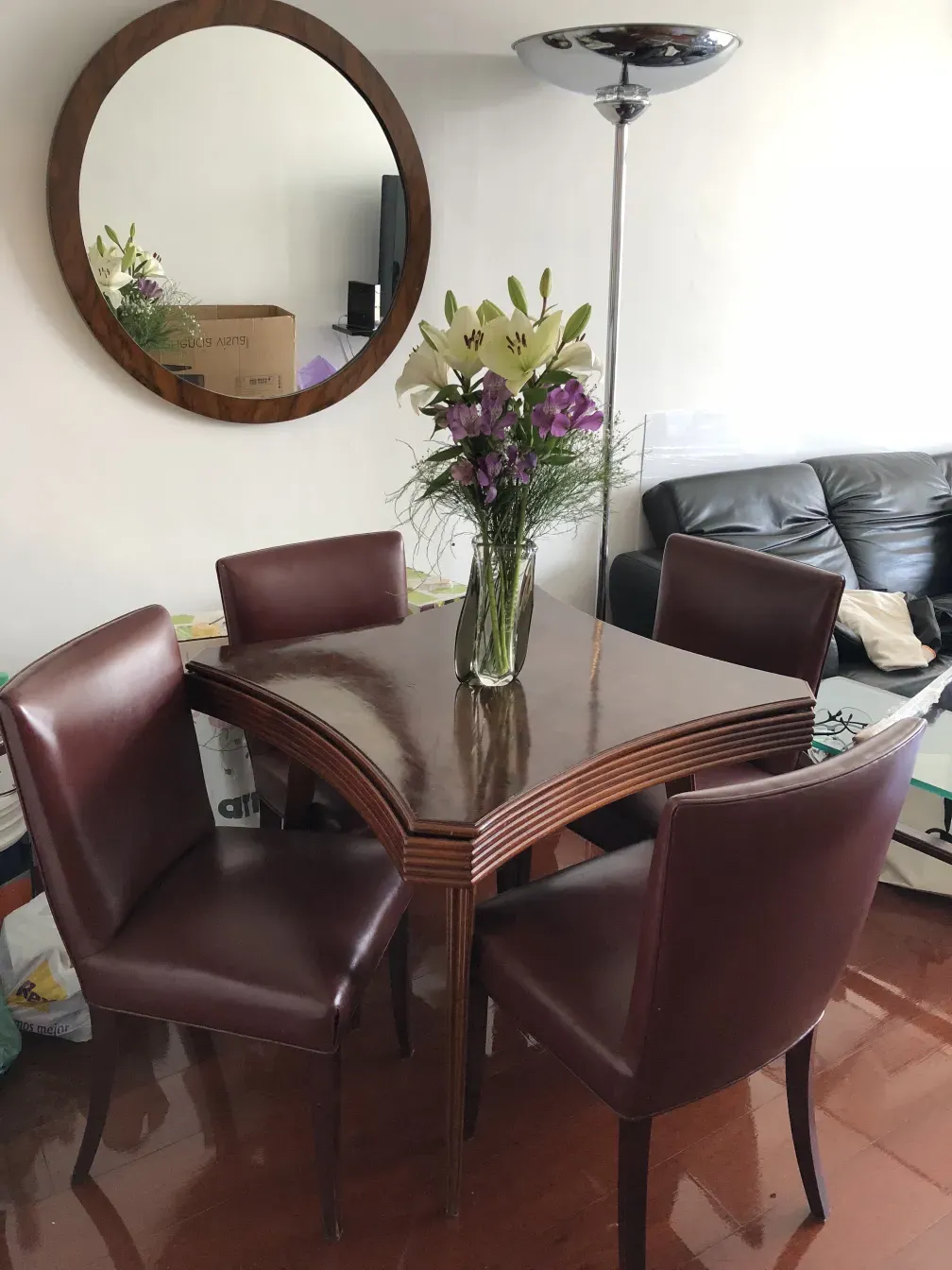 Eight antique chairs in a cozy setting with flowers