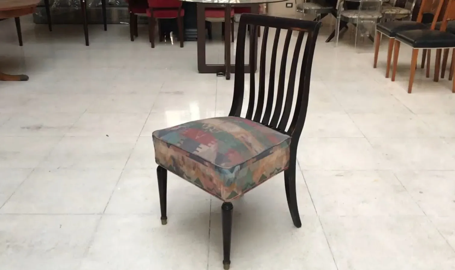 Eight antique chairs to restore, in an antique space. The design features a colorful upholstery.