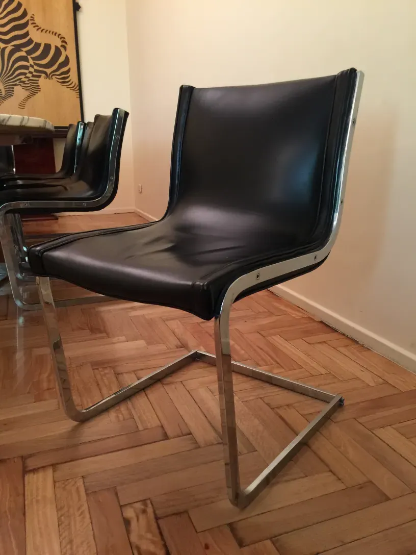 Side view of 10 antique chairs in a cozy setting.