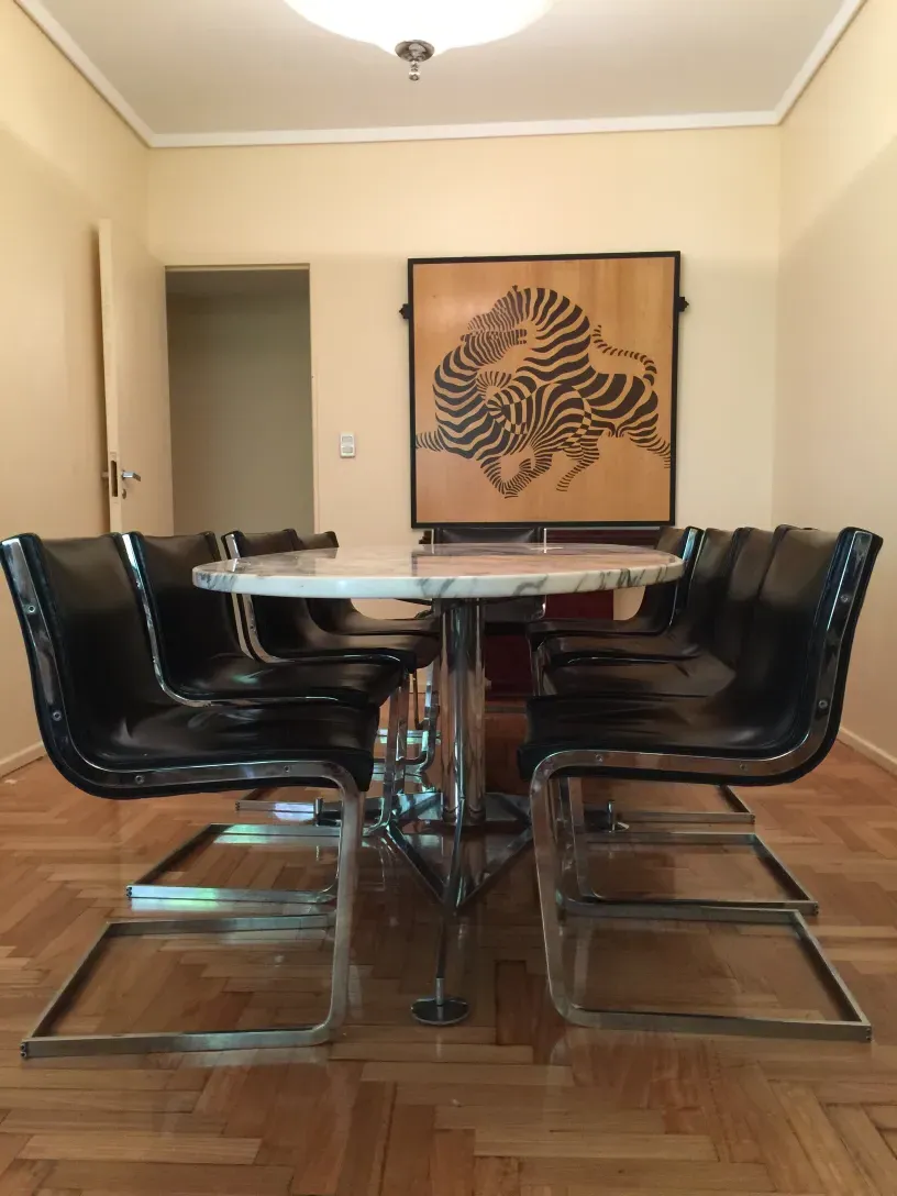 10 antique chairs ready for restoration in a modern setting