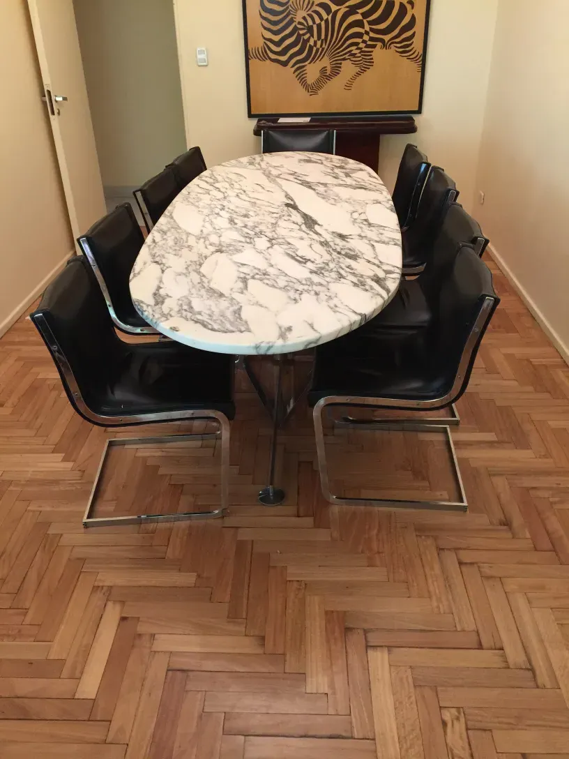 Set of 10 antique chairs in a cozy setting, ideal for restoration.